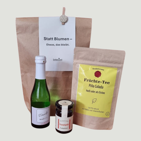 Statt Blumen Genusstüte mit Tee Piña Colada, Danke-Sekt und Fruchtaufstrich Granatapfel – Dankepräsent Düsseldorf