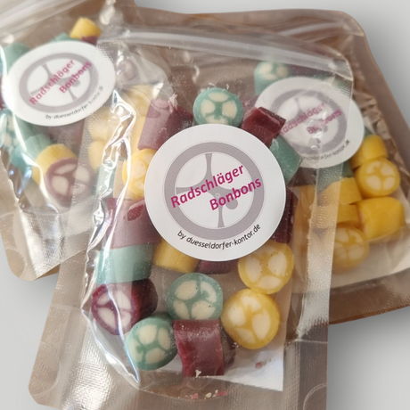 Handgefertigte Bonbons in Sonderformen auf Anfrage - hier als Radschläger-Bonbons mit Geschmack Brombeere, Orange, Heidelbeere - Düsseldorfer Kontor ❤️ 