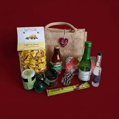 B2B-Glitzertüte von Dankepräsent weihnachtlich mit italienischen Produkten und einem Sekt mit Danke-Etikett