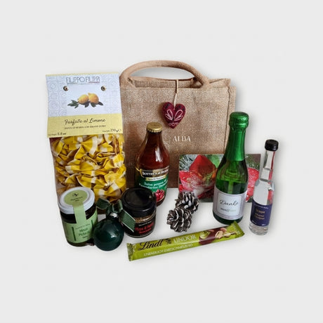 B2B-Glitzertüte von Dankepräsent ganzjährig mit italienischen Produkten und einem Sekt mit Danke-Etikett