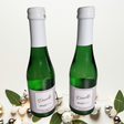 Kleine Sektflasche mit dreisprachigem Etikett: Danke, Thank You, Merci. Exklusives Firmengeschenk & Willkommensgruß von Dankepräsent Düsseldorf. Stilvolles Dankepräsent für internationales Onboarding & Events, bundesweit mit Full-Service lieferbar.